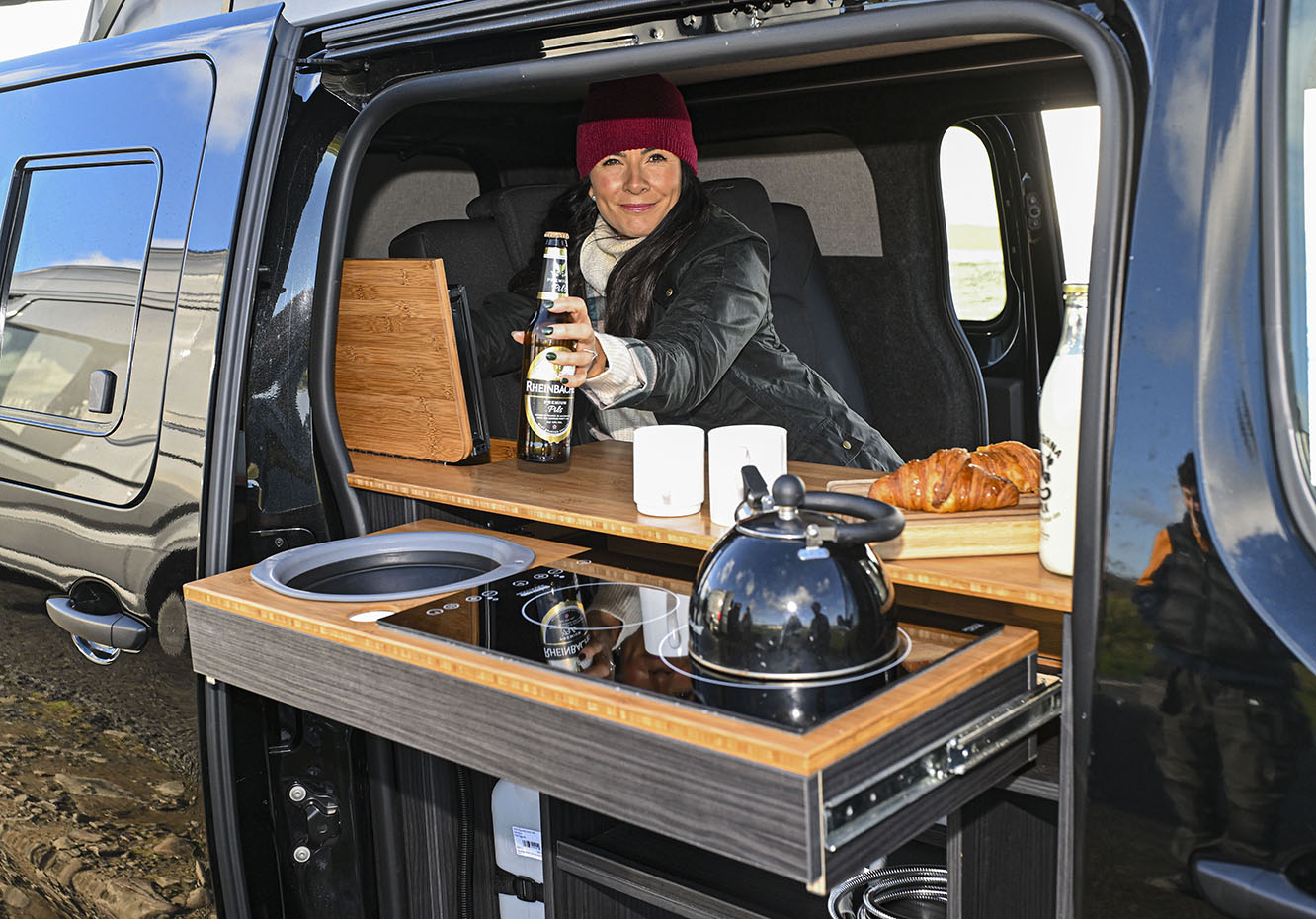 The Vanderlust Vivaro e Campers funky functionality fit out comes with flair including a top loading fridge and an indoor outdoor induction hob